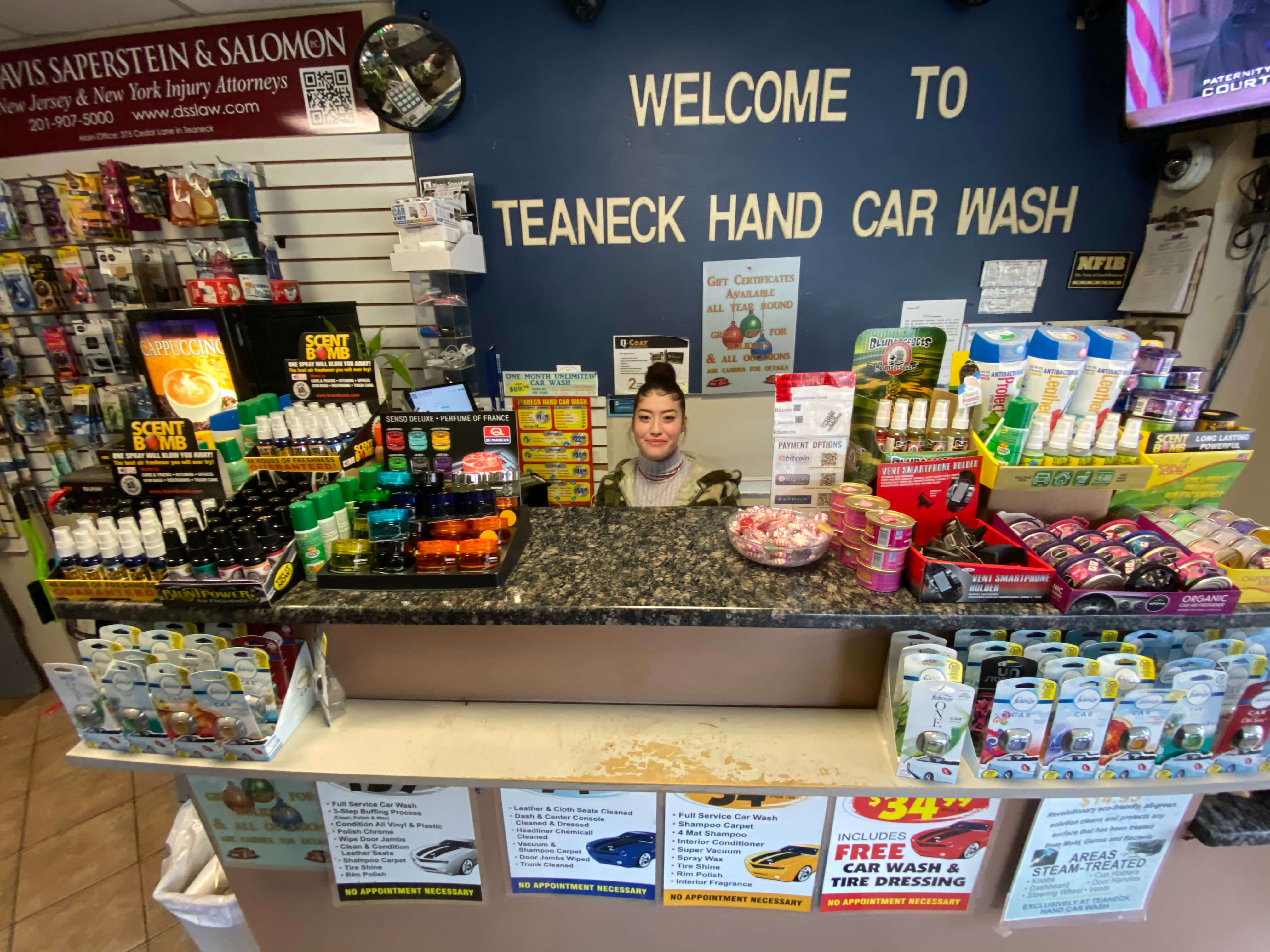 Welcome counter inside Teaneck Hand Car Wash with friendly staff